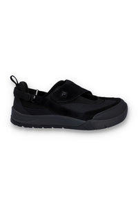Black slip-on sneakers with black strap on a white background
