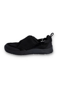 Black slip-on sneakers with black strap on a white background