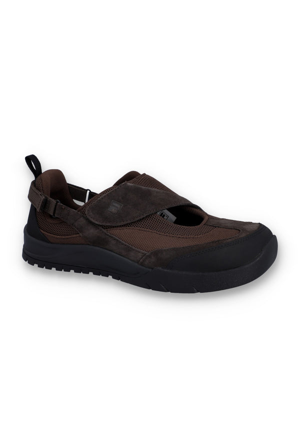 Brown flat shoe with a strap on a white background