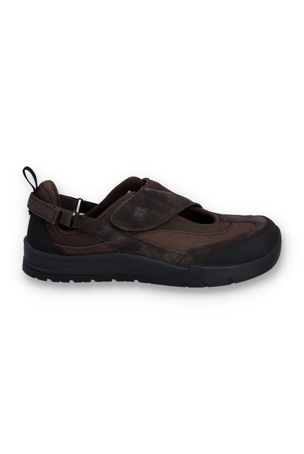 Brown flat shoe with a strap on a white background