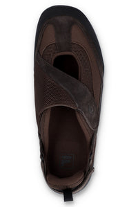 Brown flat shoe with a strap on a white background