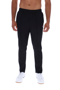 A man wearing black sweatpants and white sneakers, shown from the waist down against a plain white background.