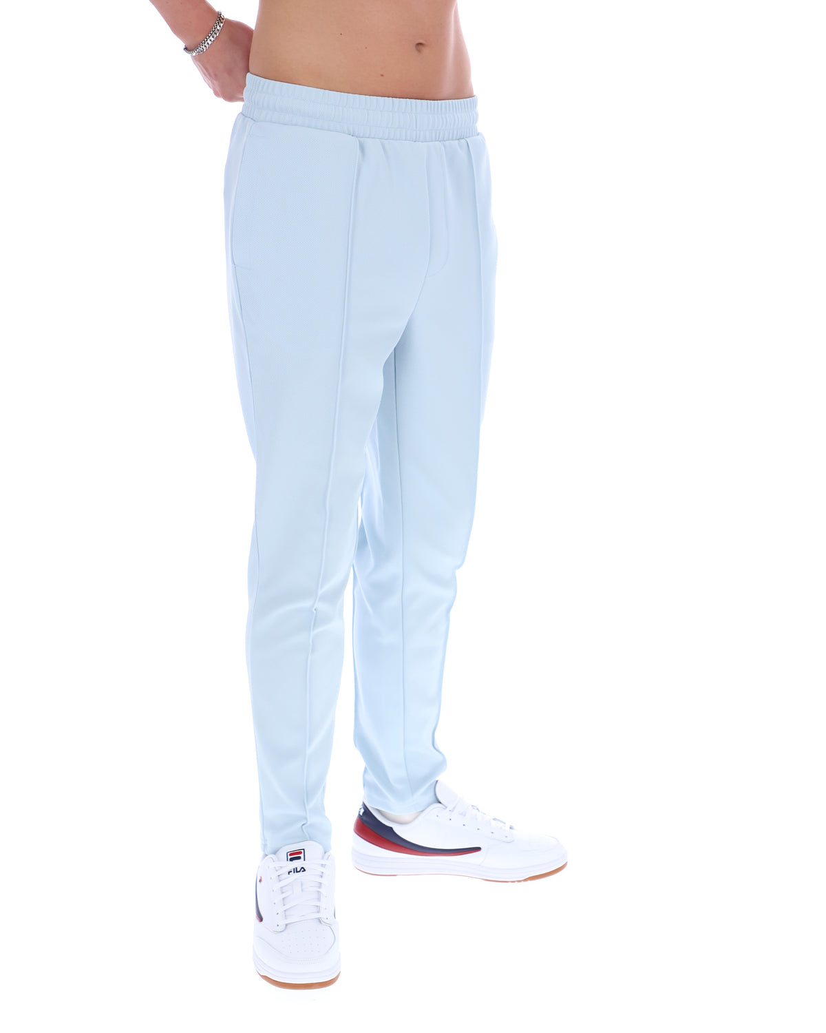 Light blue sweatpants worn by a person on a white background