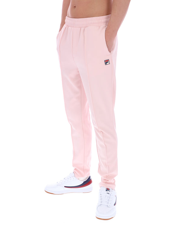 Pink sweatpants with a Fila logo on a white background