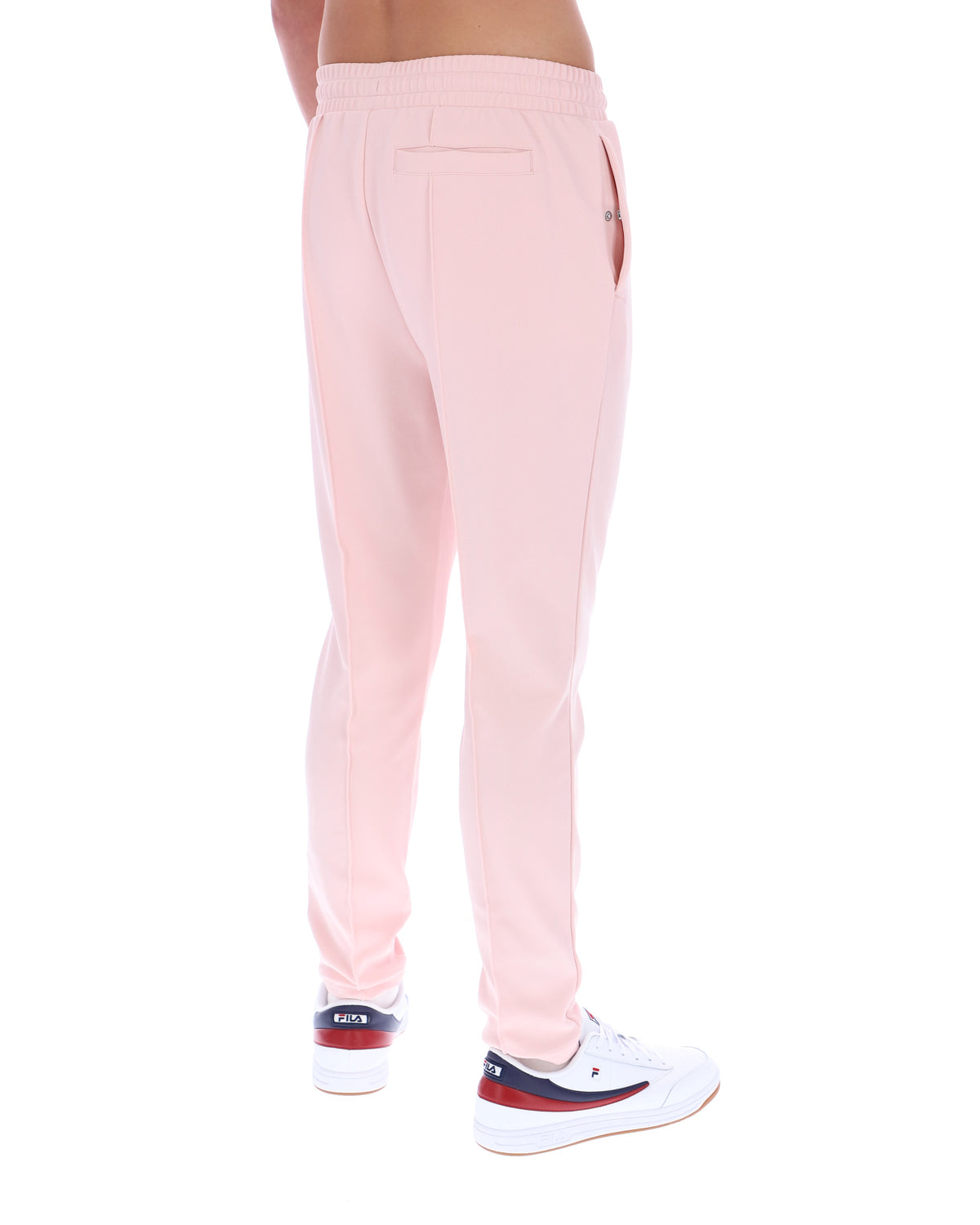 Pink sweatpants worn by a person on a white background