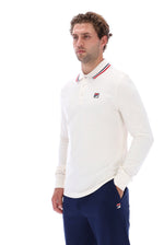 A man wearing a white long-sleeve polo shirt with a red, white, and blue striped collar and a small Fila logo on the chest, paired with navy blue pants, against a plain white background.