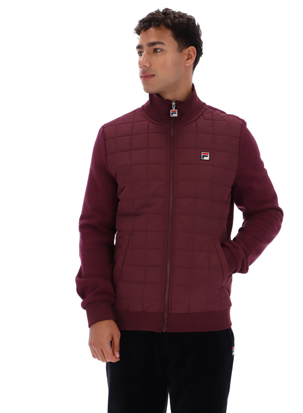 Displays a model wearing the Fig Moor 'FILA' branded Padded Front Jacket