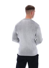 Displays a model wearing the Gardenia 'FILA' branded Noah Knitted Crew Neck
