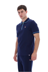 A man modeling a navy blue short-sleeve polo shirt with light blue trim and a matching navy pair of pants against a plain white background.