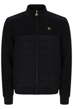 A black zip-up jacket with a quilted horizontal chest panel, a stand-up collar, and small gold Fila logo patches on the chest and zipper pull, shown against a plain white background.