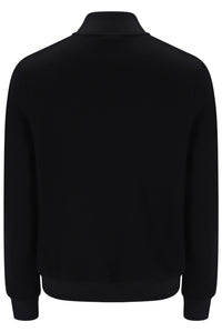 A black long-sleeve knit top with a mock neck collar, shown from the back against a plain white background.
