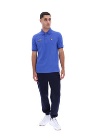 Displays a model wearing the Dazzling Blue 'FILA' branded Pablo Three-Button Tipped Rib Polo Shirt
