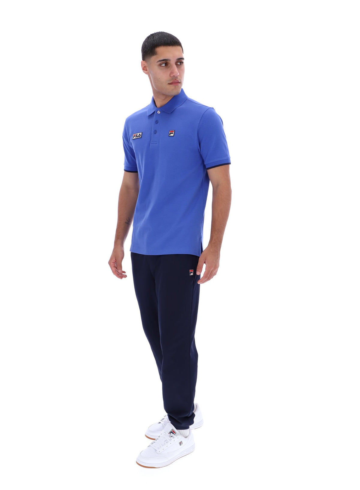 Displays a model wearing the Dazzling Blue 'FILA' branded Pablo Three-Button Tipped Rib Polo Shirt