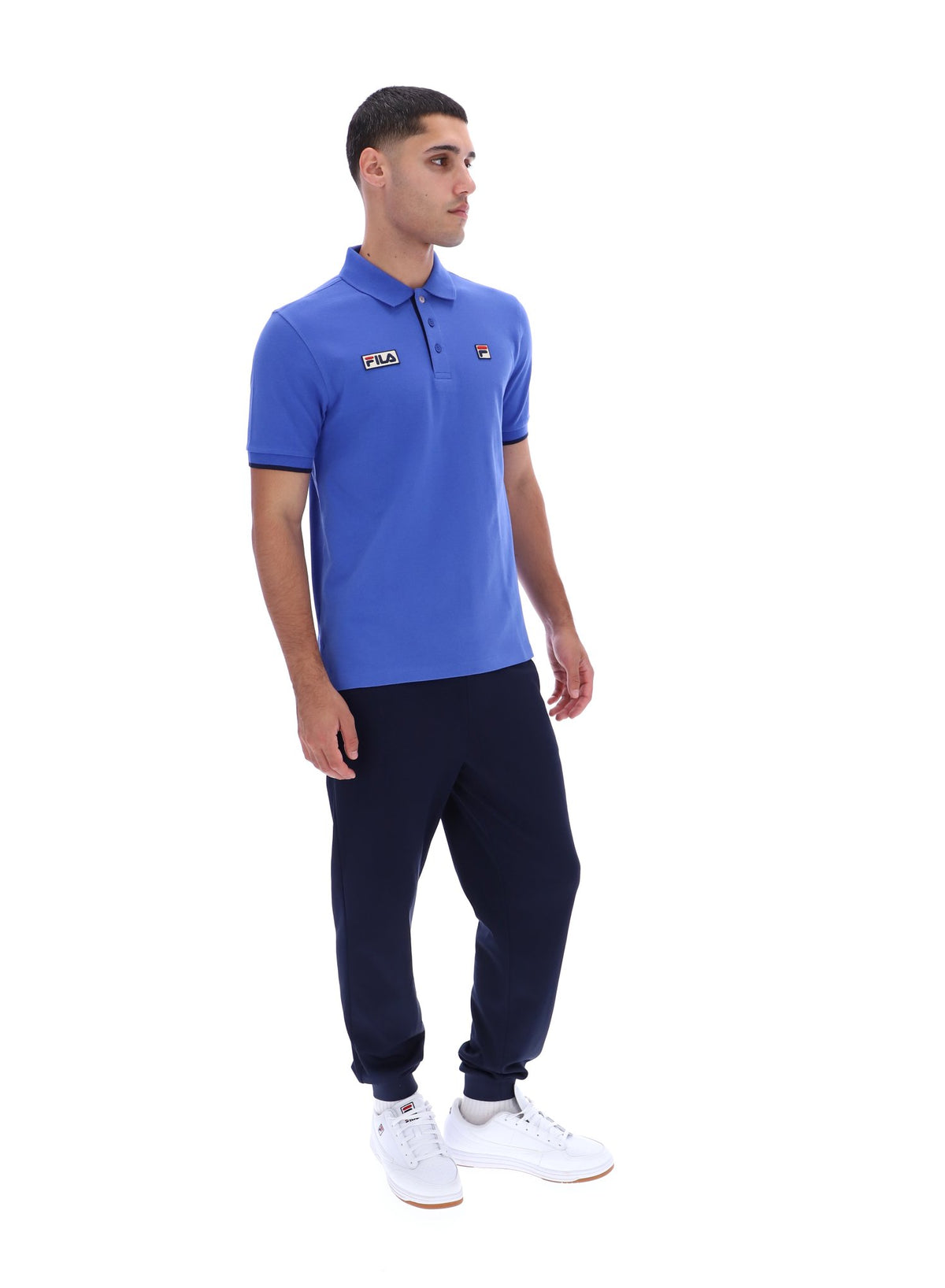 Displays a model wearing the Dazzling Blue 'FILA' branded Pablo Three-Button Tipped Rib Polo Shirt