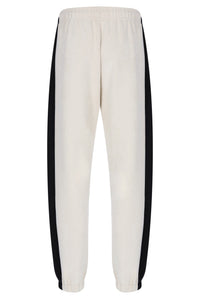 Off-white sweatpants with black side stripes, shown from the back against a plain white background.