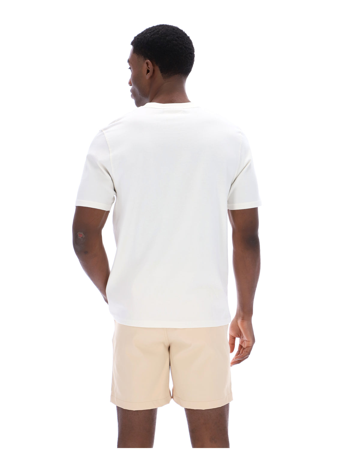 Back view of a man wearing a white t-shirt on a white background.