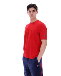 Person wearing a red shirt and blue pants with a white background