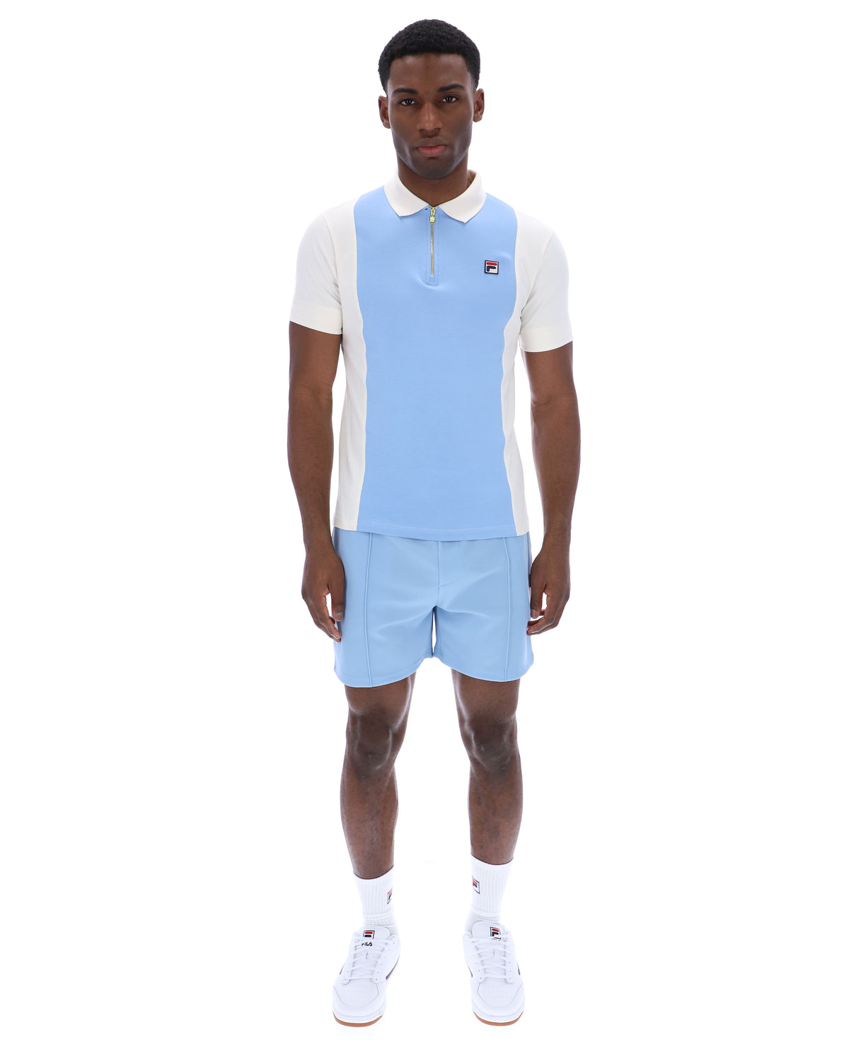 Displays a model wearing the Frozen 'Fila' branded Fjord Pierro Zip Up Polo
