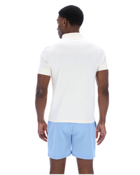 Displays a model wearing the Frozen 'Fila' branded Fjord Pierro Zip Up Polo