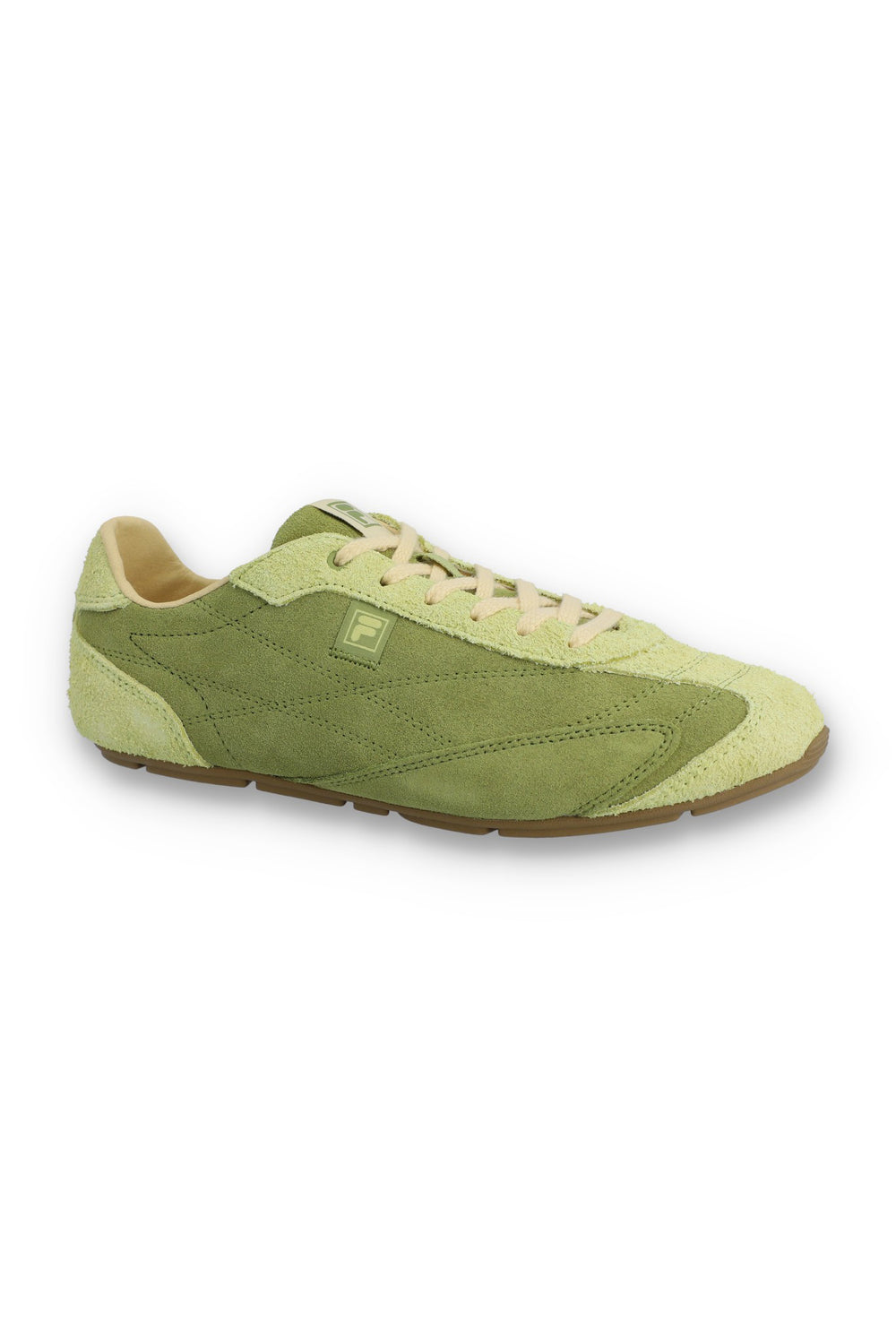 Profile view of a FILA Ritmo trainer in sage green suede, featuring a low-profile silhouette, cream laces, a light green embossed 'F' logo on the side panel, and a slim brown rubber sole against a white background.
