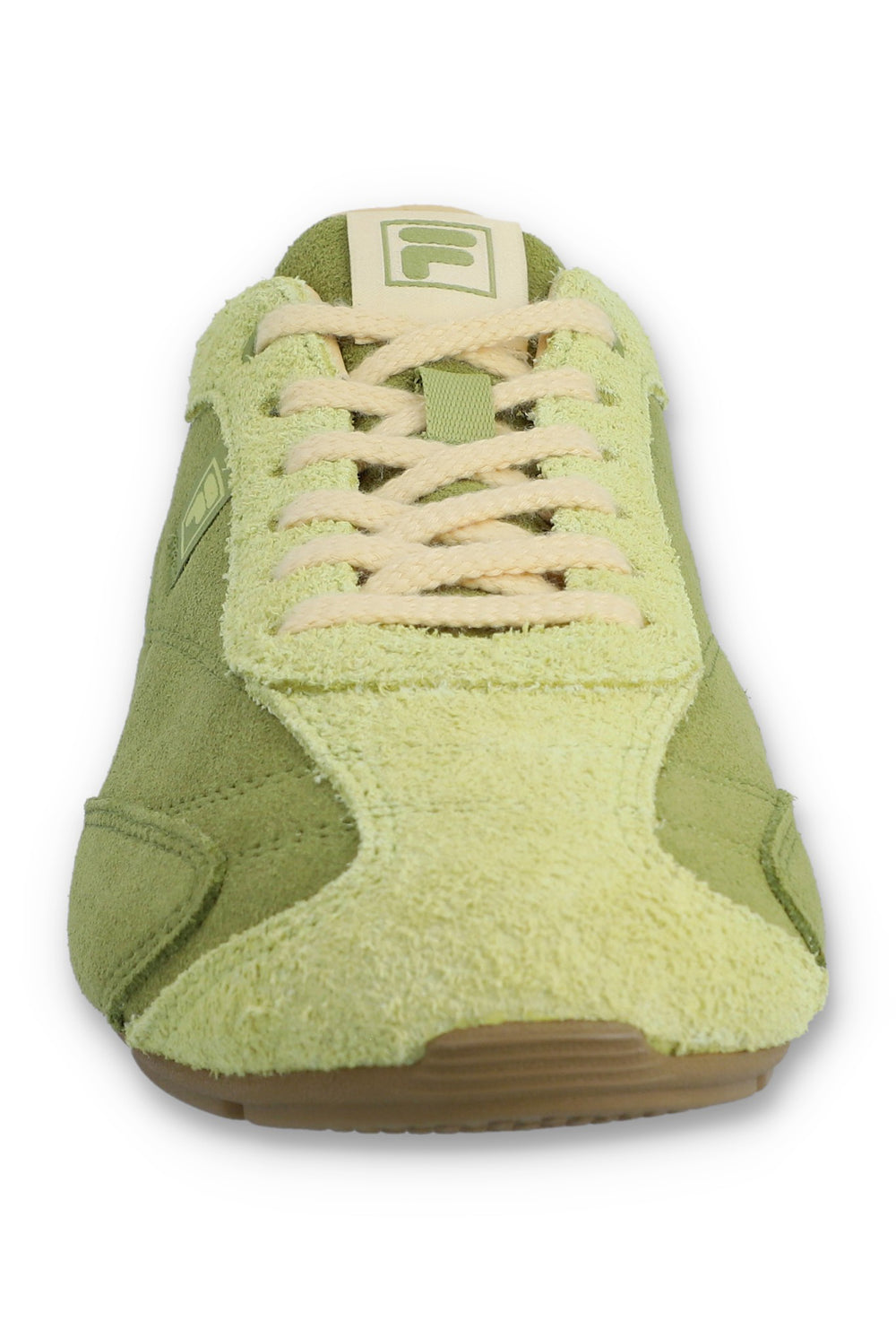 Front view of a FILA Ritmo trainer in green suede, showcasing the pale green textured toe box, contrasting cream laces, and a cream FILA 'F' logo on the tongue against a white background.
