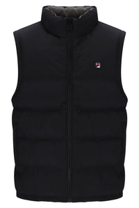A black sleeveless puffer vest with a high stand-up collar and front zipper, featuring a small red, white, and blue Fila logo on the left chest, shown against a plain white background.