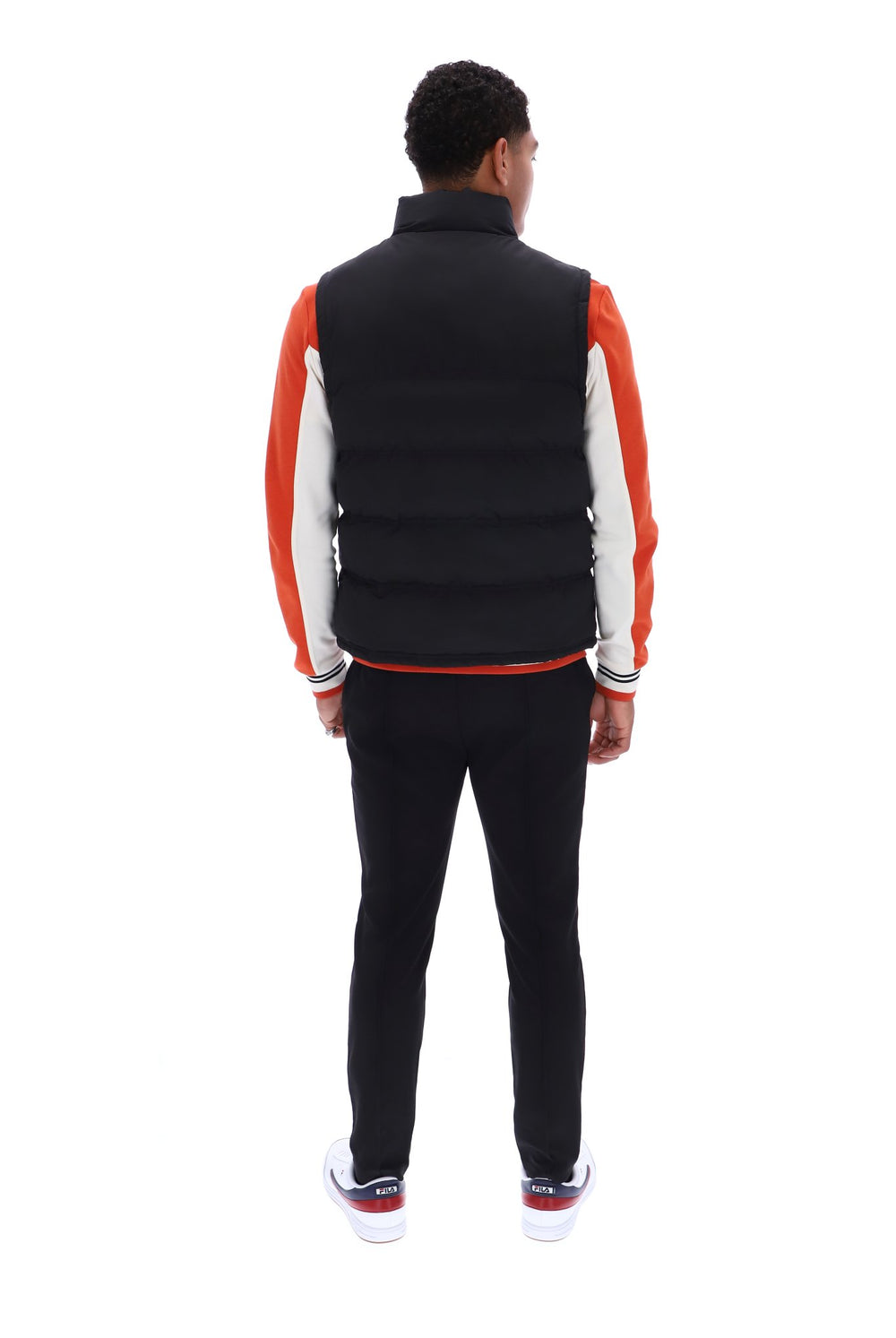 Displays a model wearing the Black/ Gunmetal 'FILA' branded Rodri Gilet