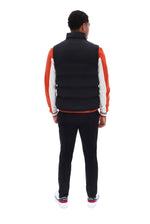Displays a model wearing the Black/ Gunmetal 'FILA' branded Rodri Gilet
