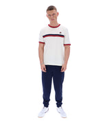 Man wearing a white and navy striped shirt with dark blue pants on a white background