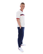 Man wearing a white and navy tracksuit with a red stripe on a white background