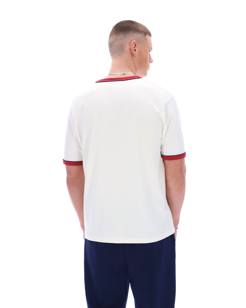 Man wearing a white sports jersey with red accents on a white background