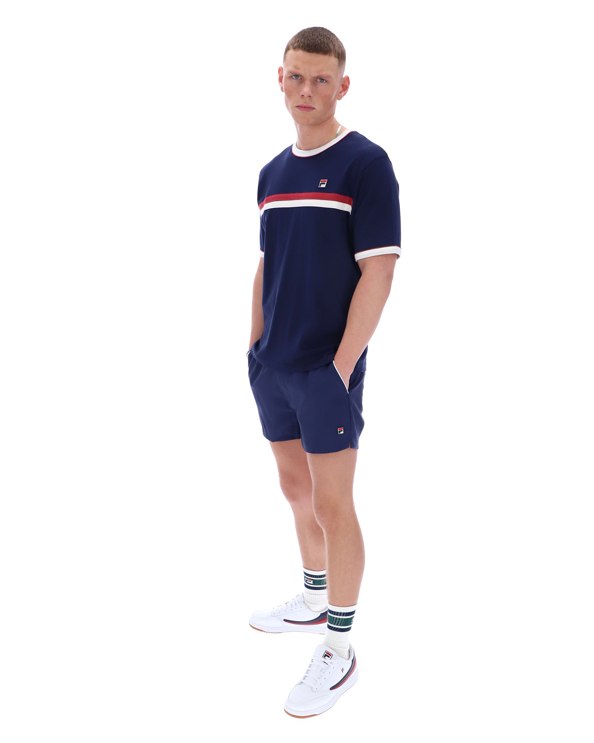 Person wearing a navy blue outfit with white accents on a white background