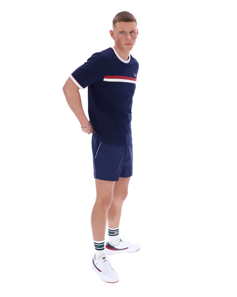 Person wearing a navy sports outfit with a red and white stripe on a white background