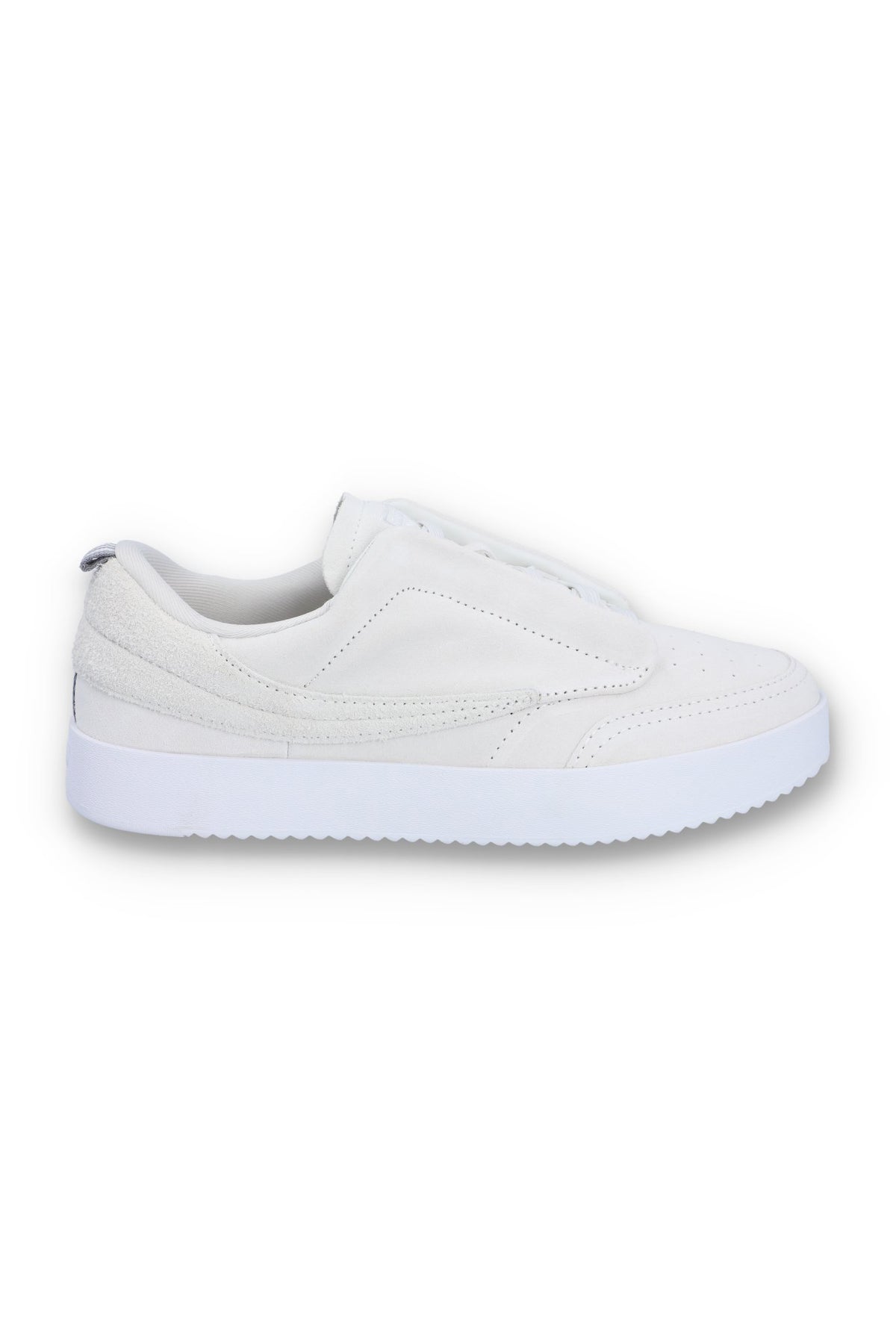 A white suede tennis trainer with low-top design and lace-up closure.