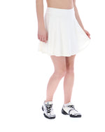 Person wearing a white skirt and white shoes on a white background