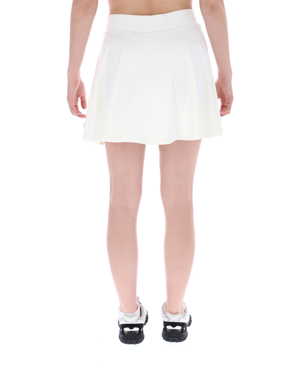 White skirt worn by a person on a white background