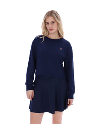 Woman wearing a navy blue sweatshirt and skirt set on a white background