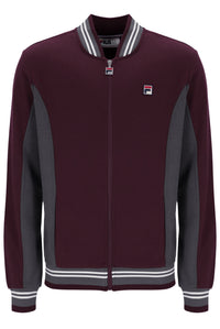 A Fila zip-up jacket in maroon with dark gray colorblock panels on the sides and sleeves, featuring a striped ribbed collar, hem, and cuffs, and the Fila logo on the chest.