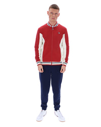 Man wearing a red and white tracksuit with a logo on a white background