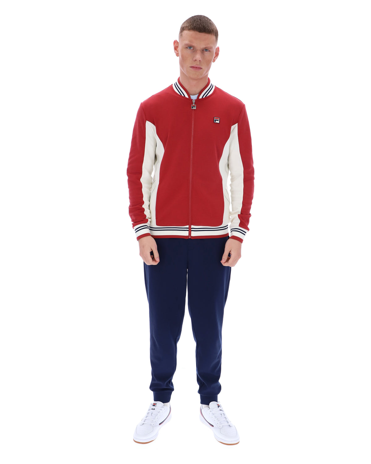 Man wearing a red and white tracksuit with a logo on a white background