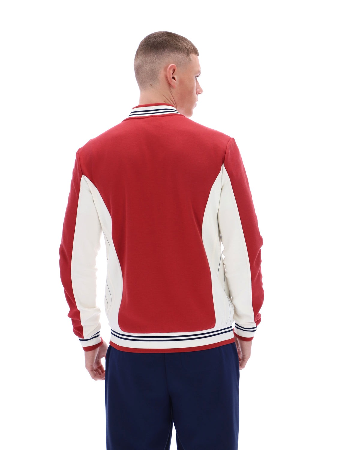 Man wearing a red and white varsity jacket on a white background