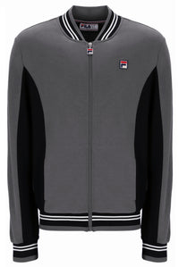A gray and black Fila zip-up track jacket with white striped ribbing on the collar, hem, and cuffs, and a small Fila logo patch on the left chest.