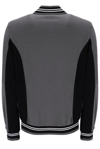 A gray and black color-blocked knit sweater with white striped ribbed trim on the collar, cuffs, and hem, shown from the back.