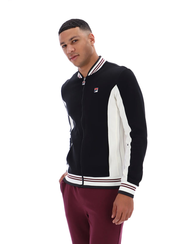 Man wearing a black and white jacket with a visible brand logo on a white background