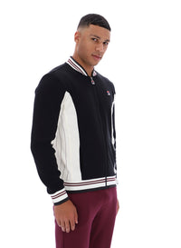 Man wearing a black and white jacket with a visible brand logo on a white background