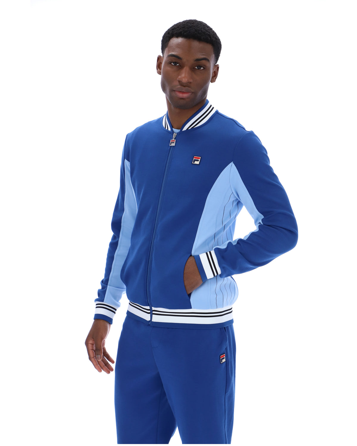 Man wearing a blue tracksuit with a white background