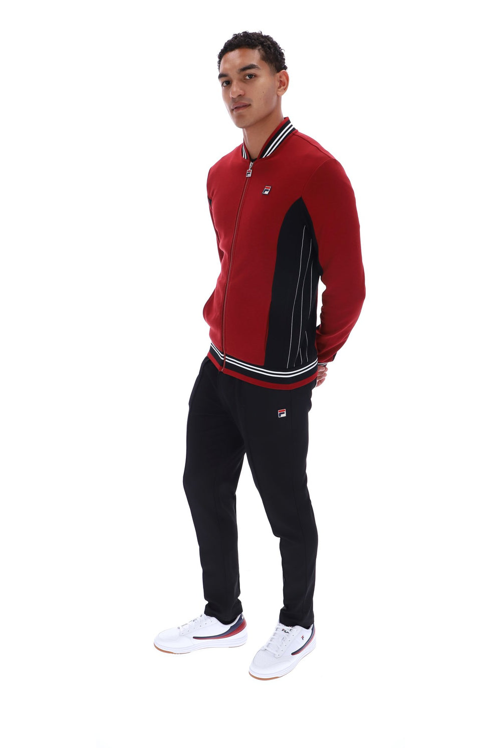 Displays a model wearing the Sun Dried 'FILA' branded Tomato/ Black/White Settanta Baseball Track Top