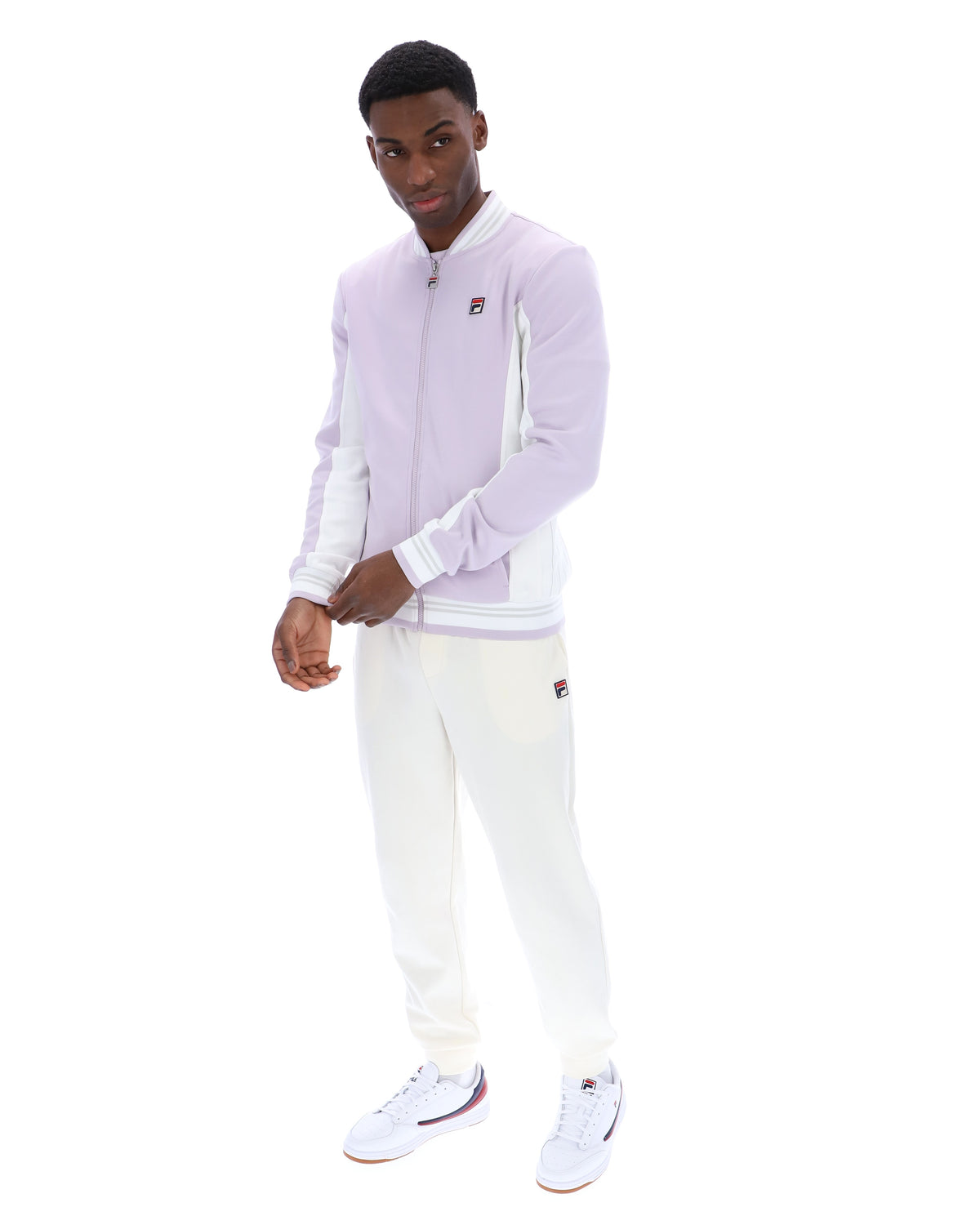 Displays a model wearing the Misty Lilac 'FILA' branded Settanta Baseball Track Top