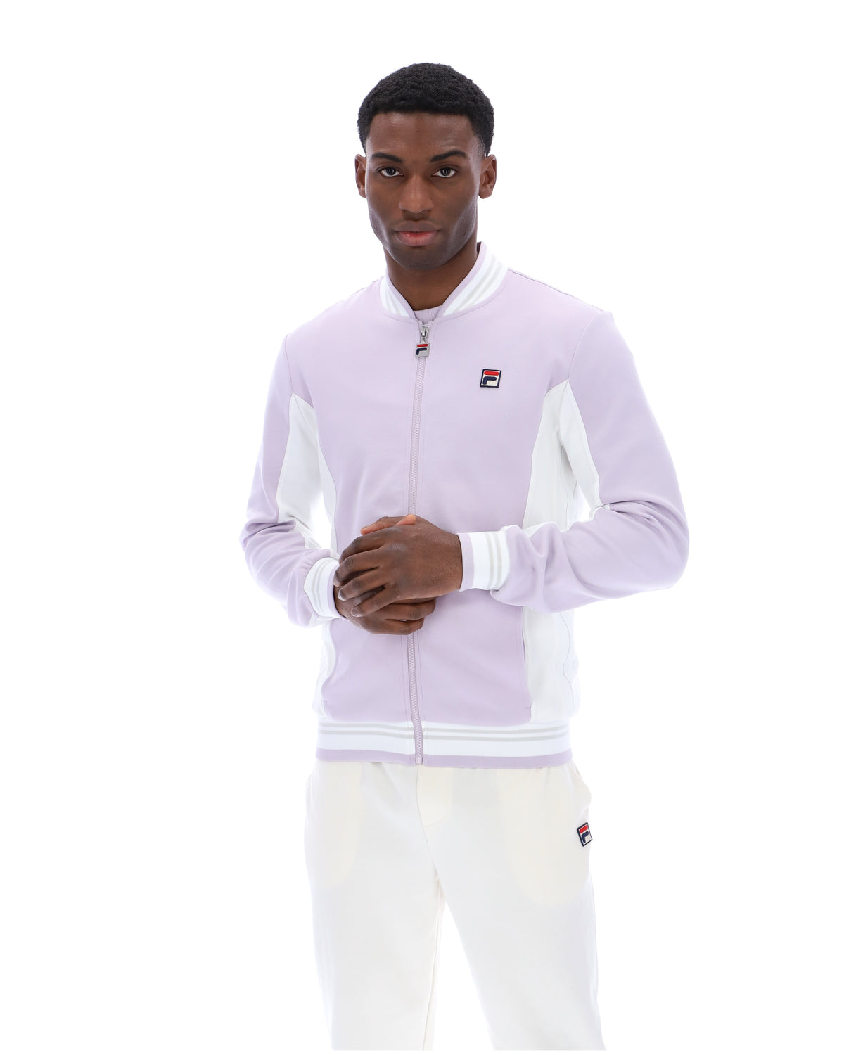 Displays a model wearing the Misty Lilac 'FILA' branded Settanta Baseball Track Top