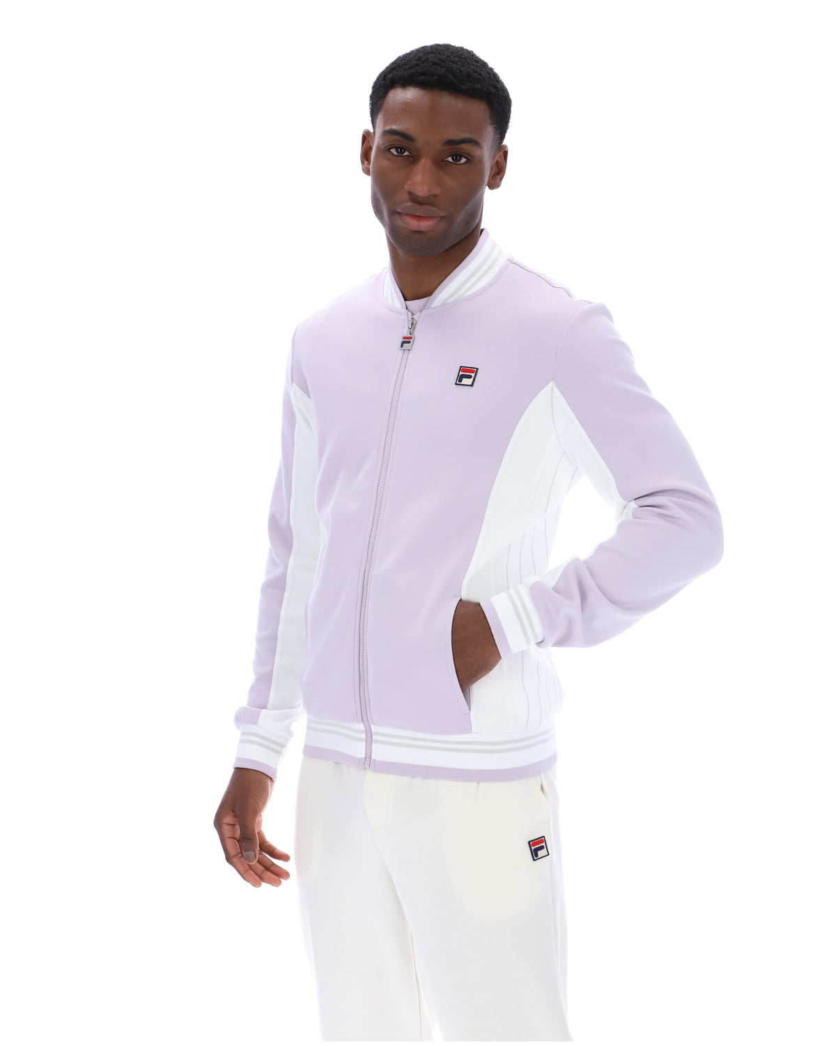 Displays a model wearing the Misty Lilac 'FILA' branded Settanta Baseball Track Top